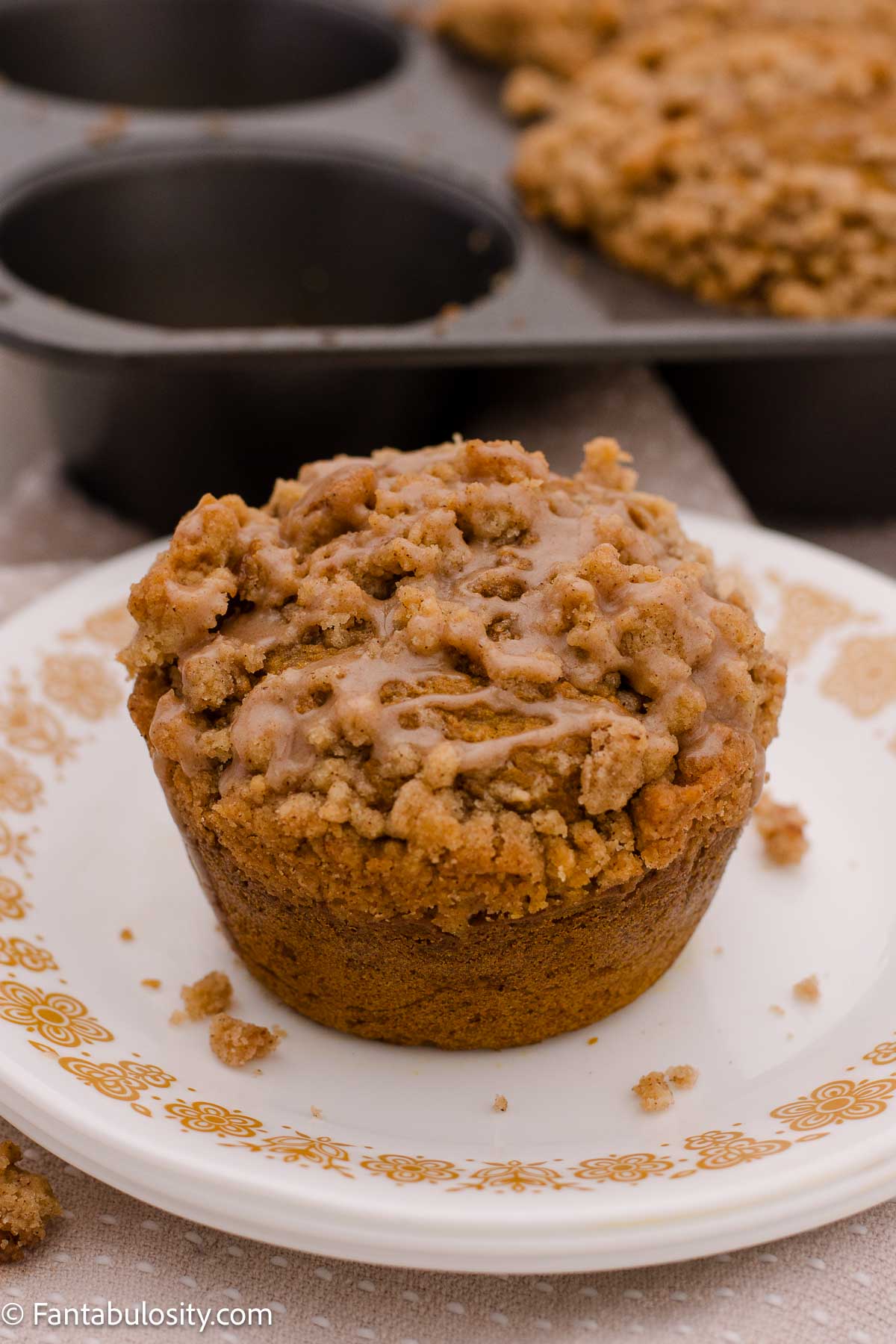 Jumbo pumpkin muffin on vintage plate.