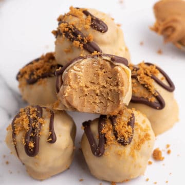 Close up photo of a stack of Biscoff Truffles with the center truffle missing a bite