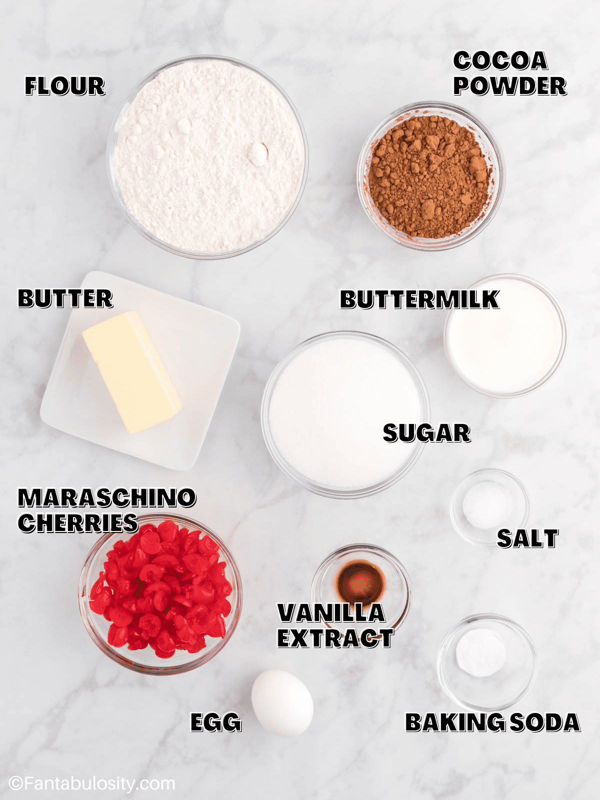 Ingredients for chocolate cherry cookies laid out on a counter with labels on the image.