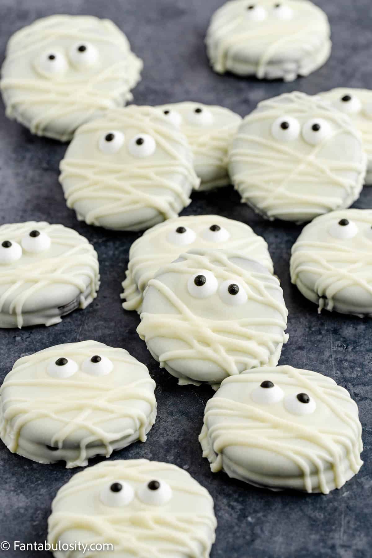 A photo of white chocolate dipped Oreos decorated to look like mummies