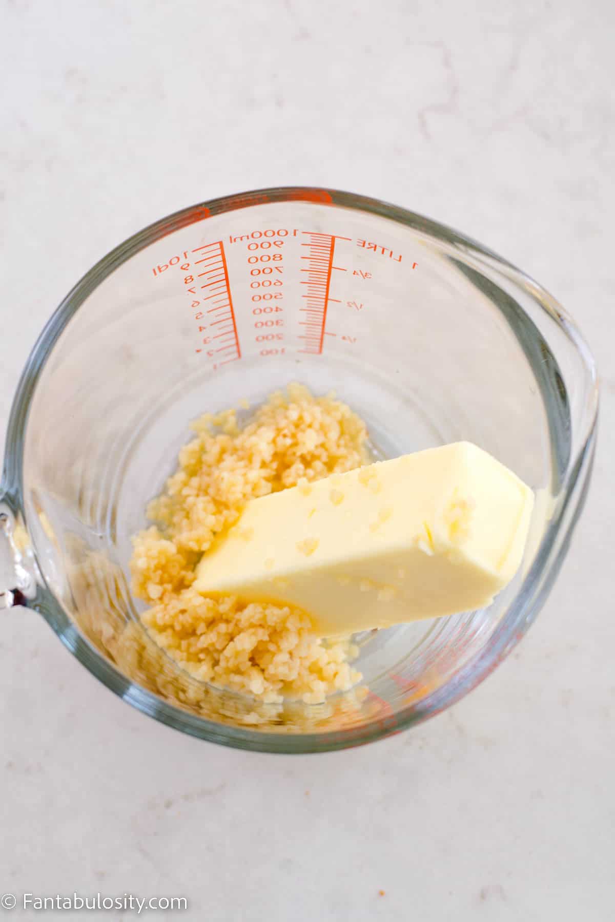 butter and garlic in measuring cup