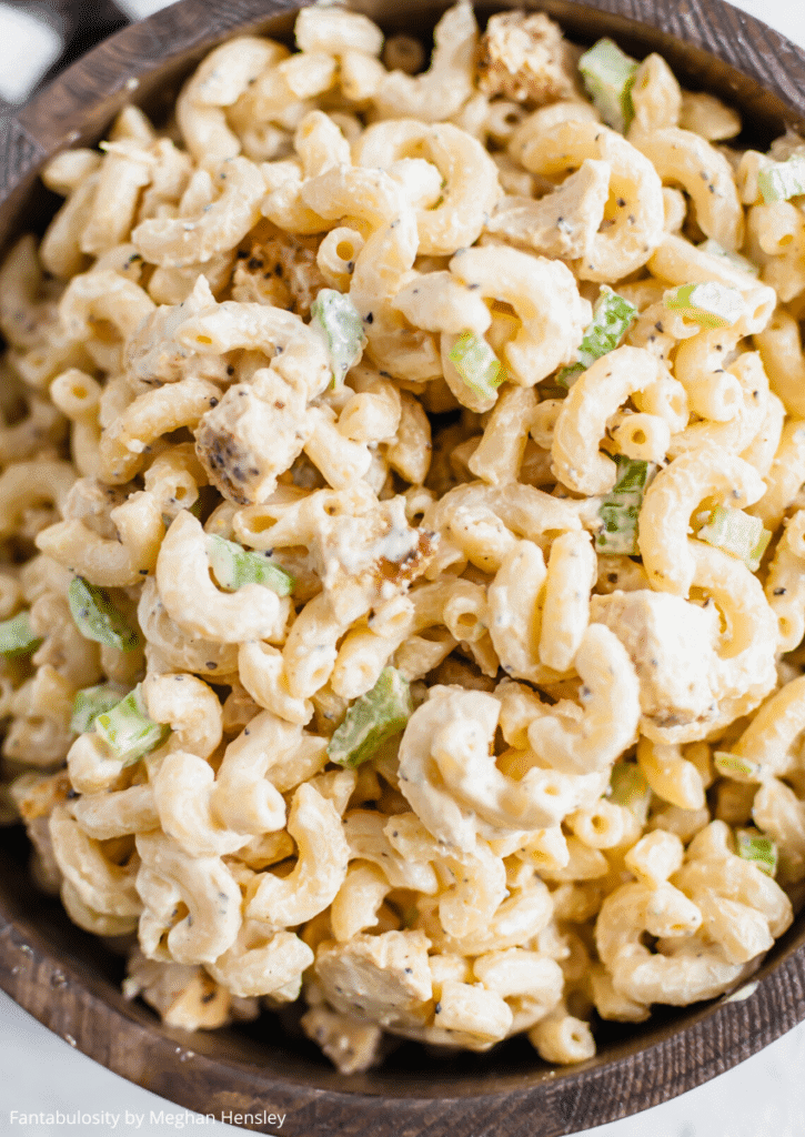 A bowl of chicken macaroni salad in a large serving bowl.