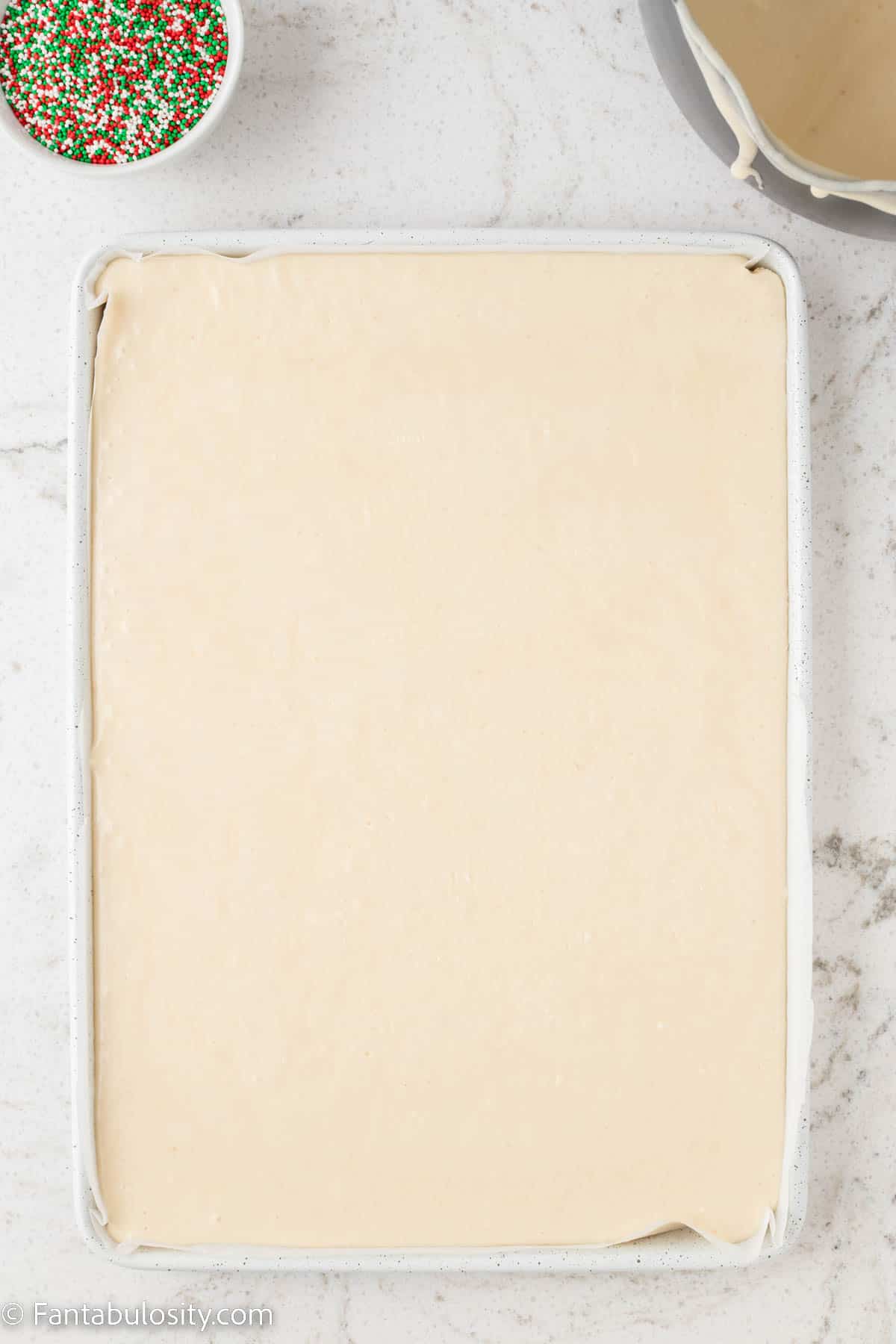 A 9x13 pan is filled with smooth white fudge