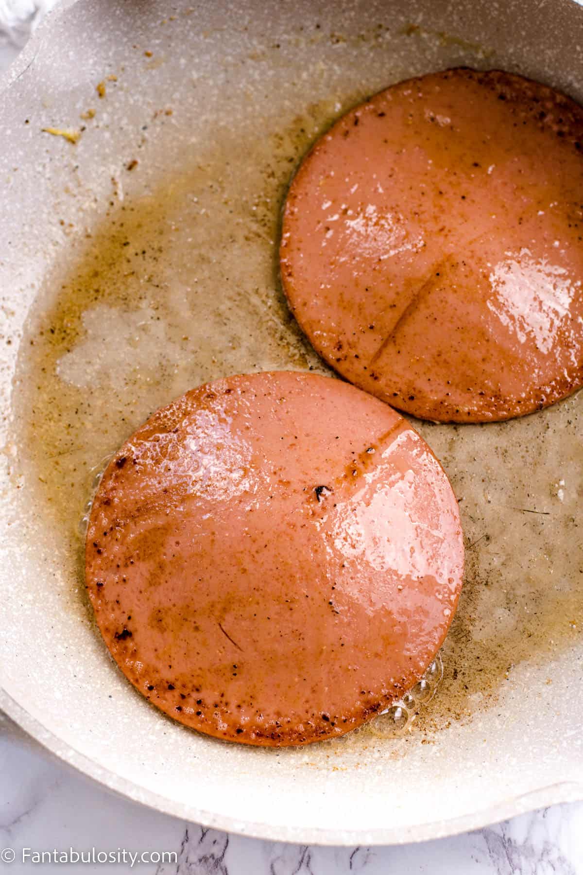 2 slices of bologna in frying pan