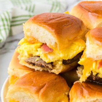 A close up photo of a stack of breakfast slider sandwiches