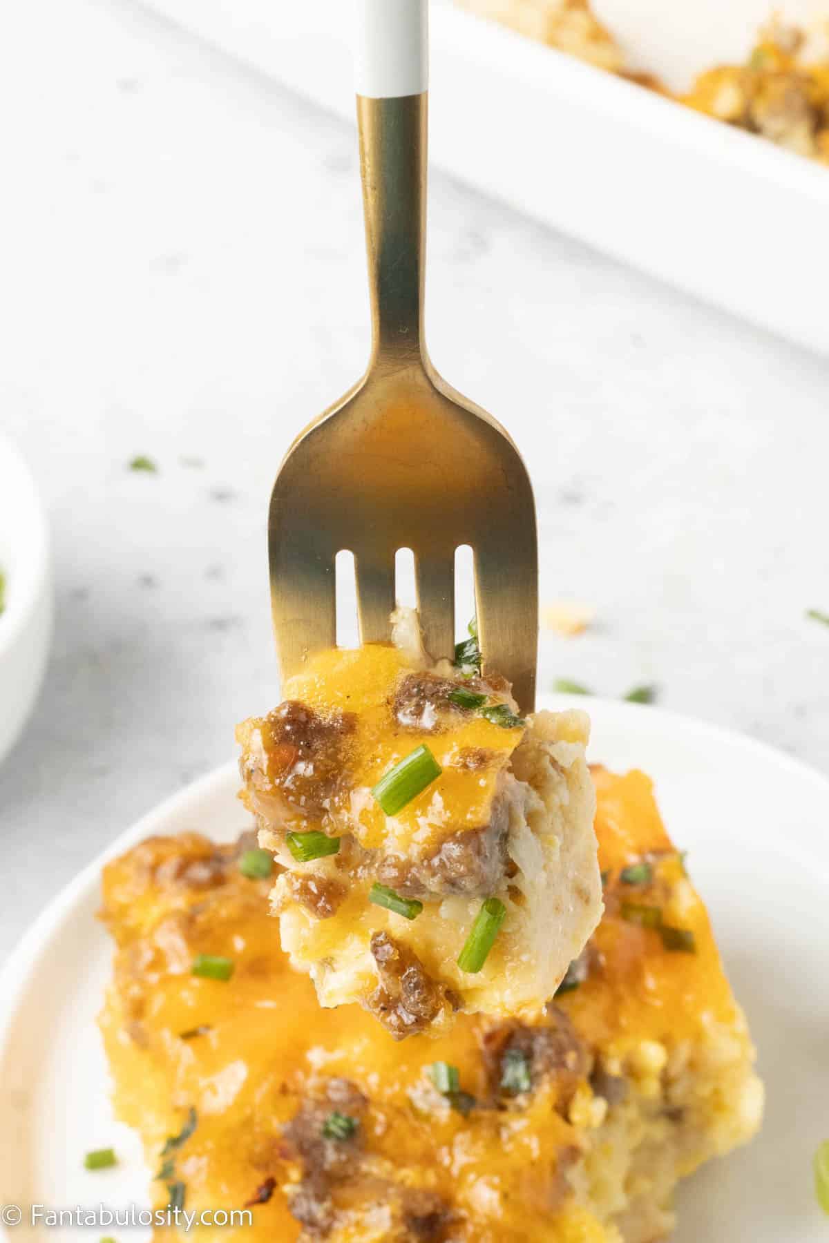 Bite of sausage and egg casserole on fork