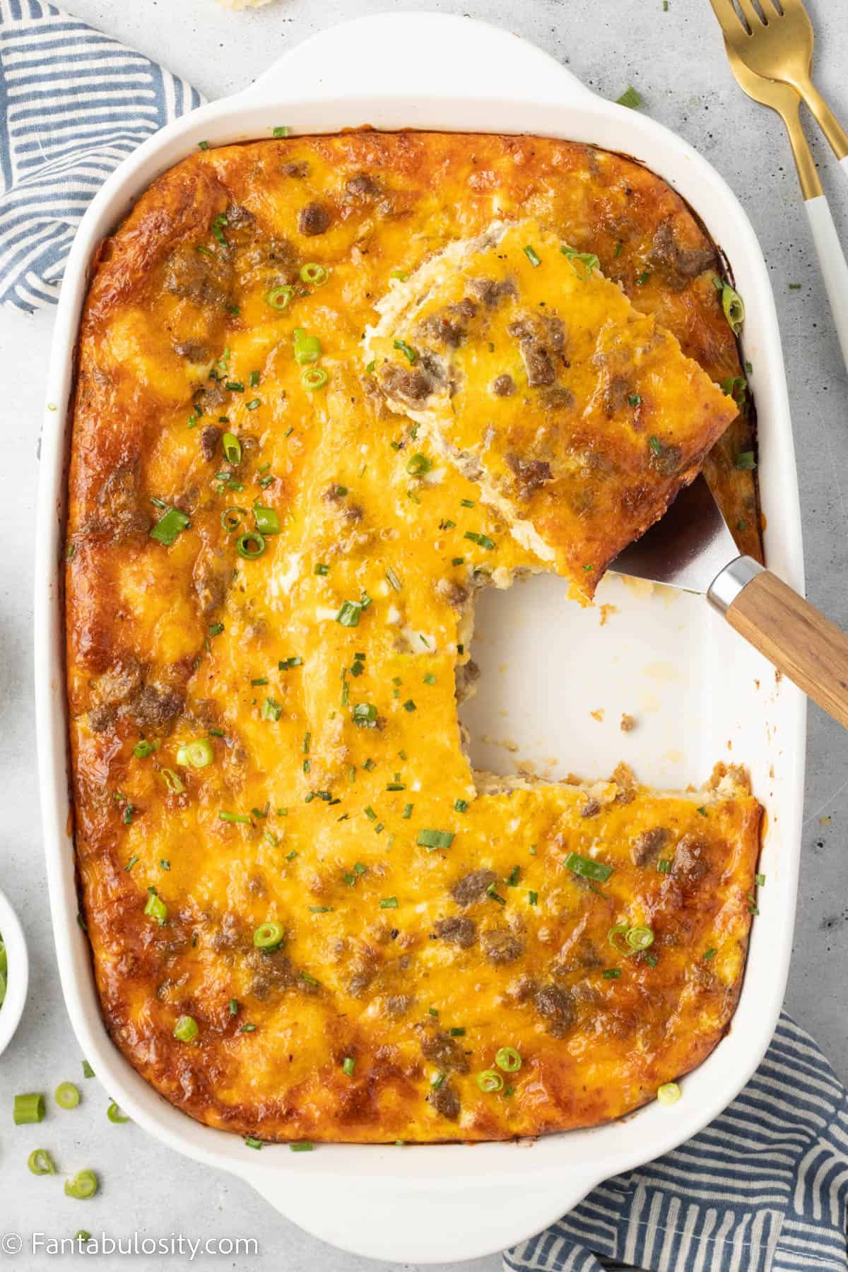 Serving of casserole being lifted out of dish with spatula