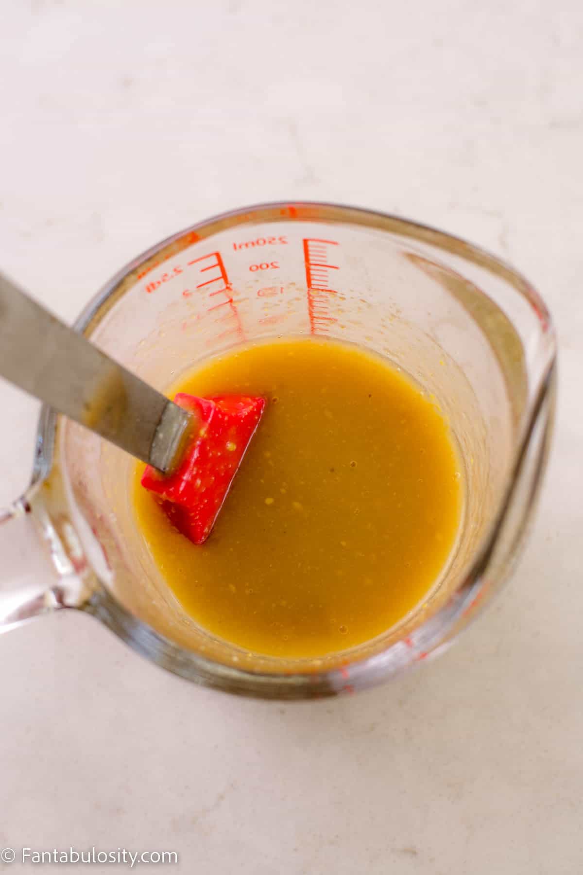 Melted butter and seasonings in glass measuring bowl