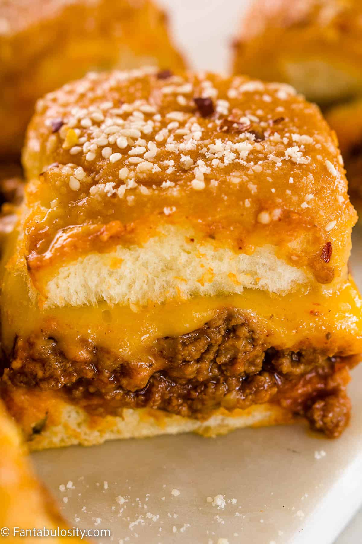 Sloppy Joe Sliders with cheese, on white marble table