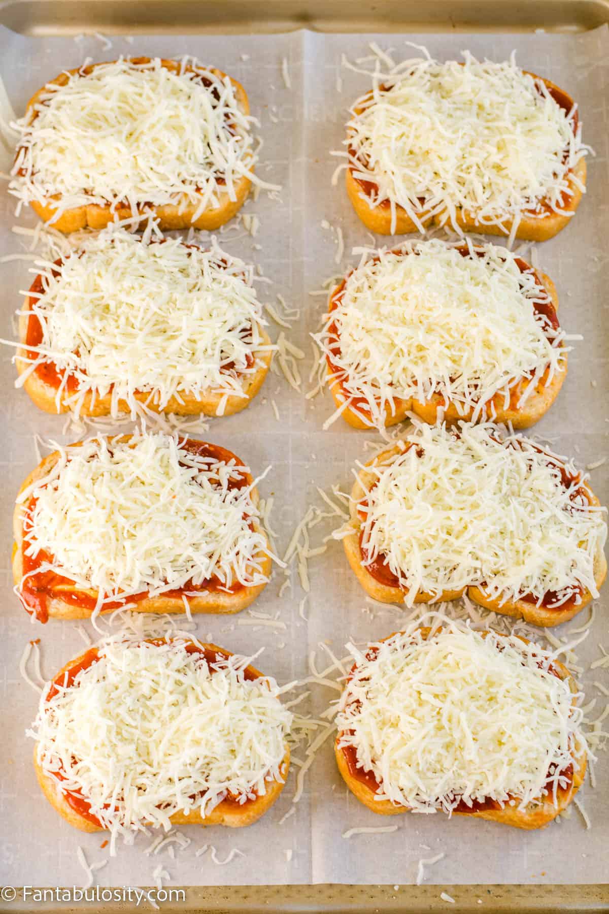 Shredded mozzarella cheese on top of garlic cheese toast