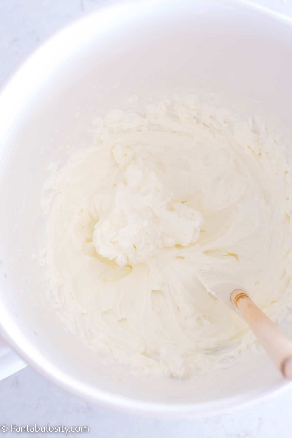 Homemade whipped cream in white mixing bowl