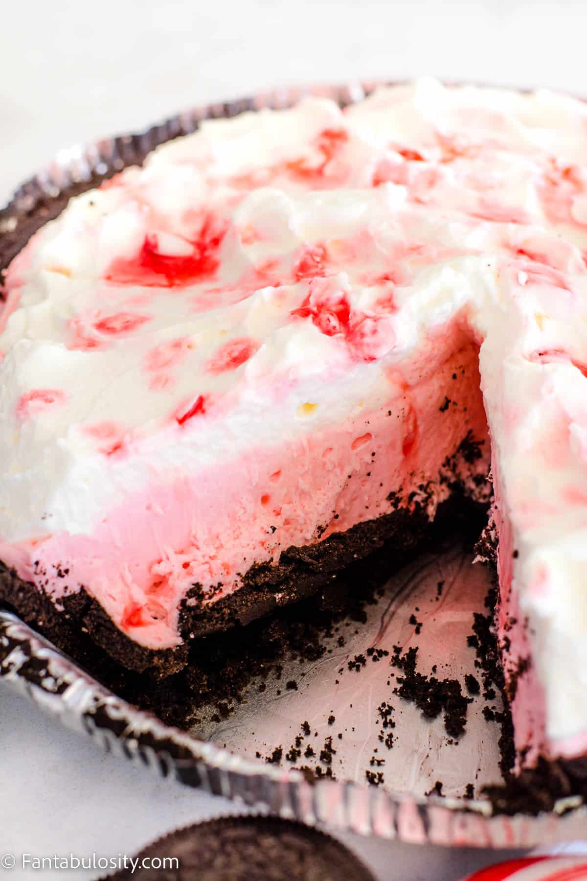Candy cane pie with a slice cut out
