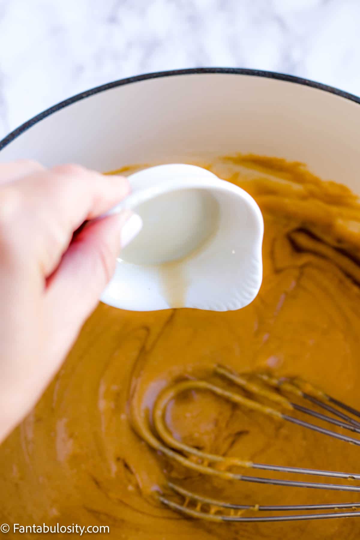 Vanilla pouring in to peanut butter