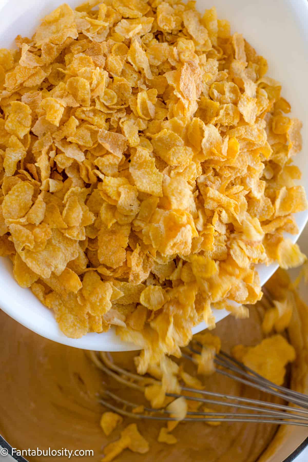 Cornflakes pouring in to peanut butter
