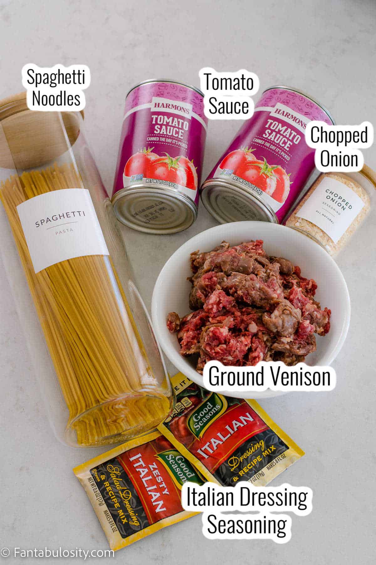 Ingredients on white marble counter for venison spaghetti