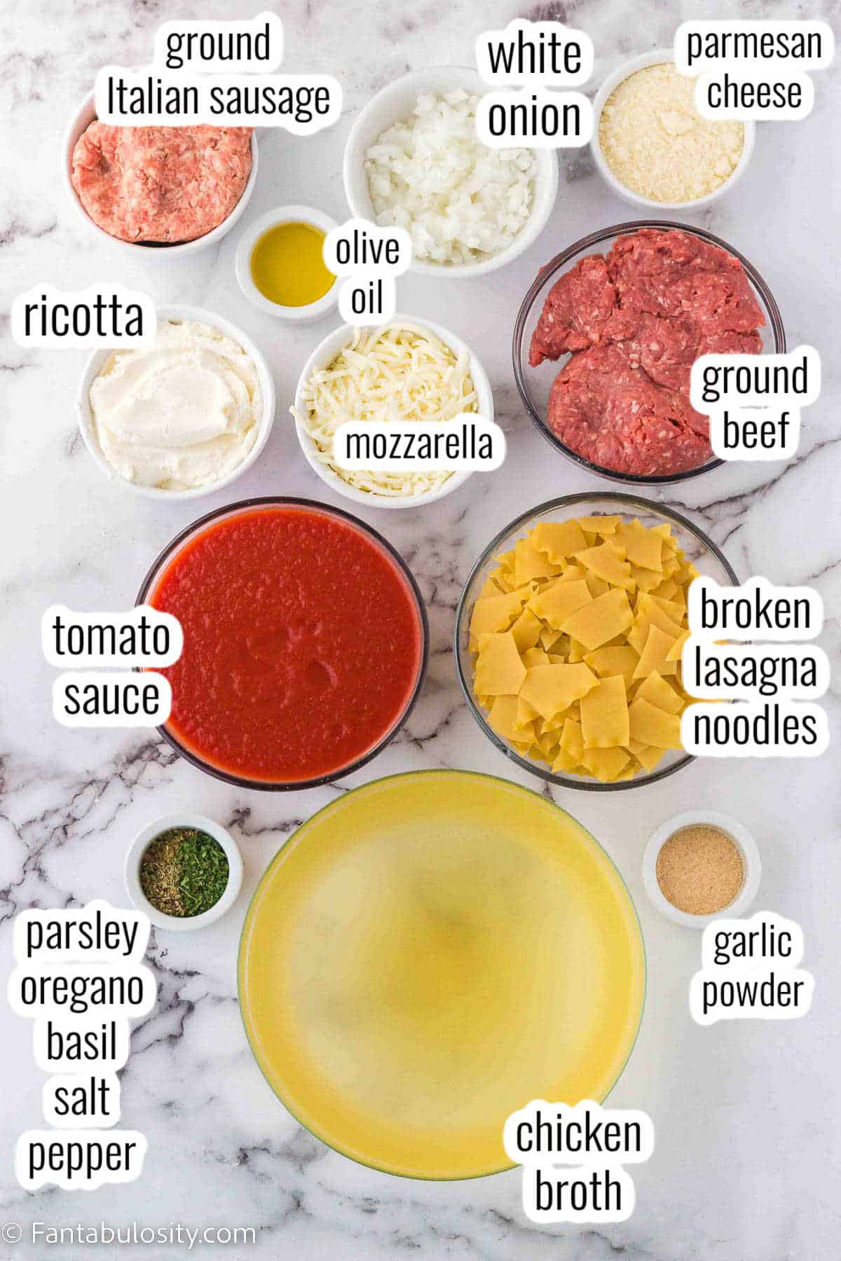 Ingredients for lasagna soup on marble counter.