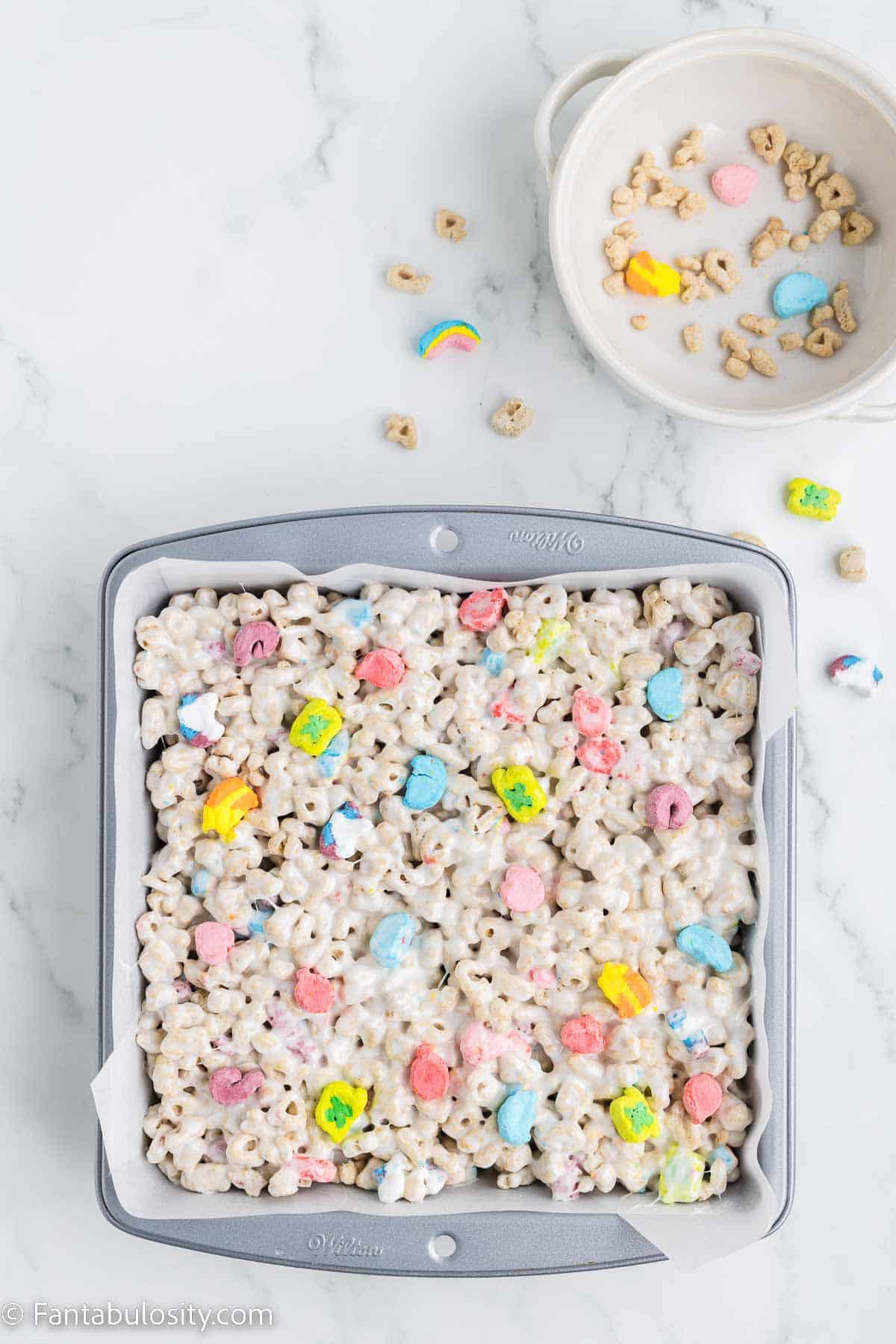 Lucky Charms and melted marshmallows poured in to baking dish.