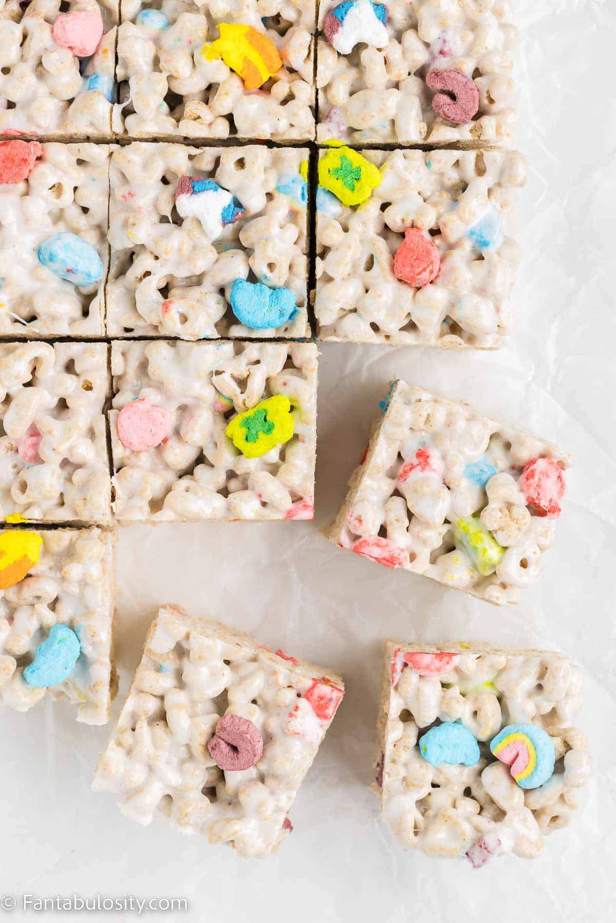 Lucky Charms treats sliced in to squares on counter.