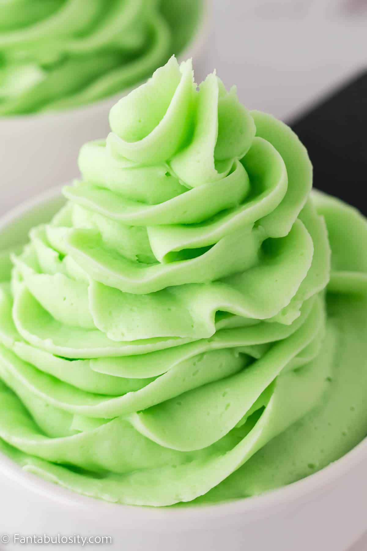 Mint buttercream in a white bowl.