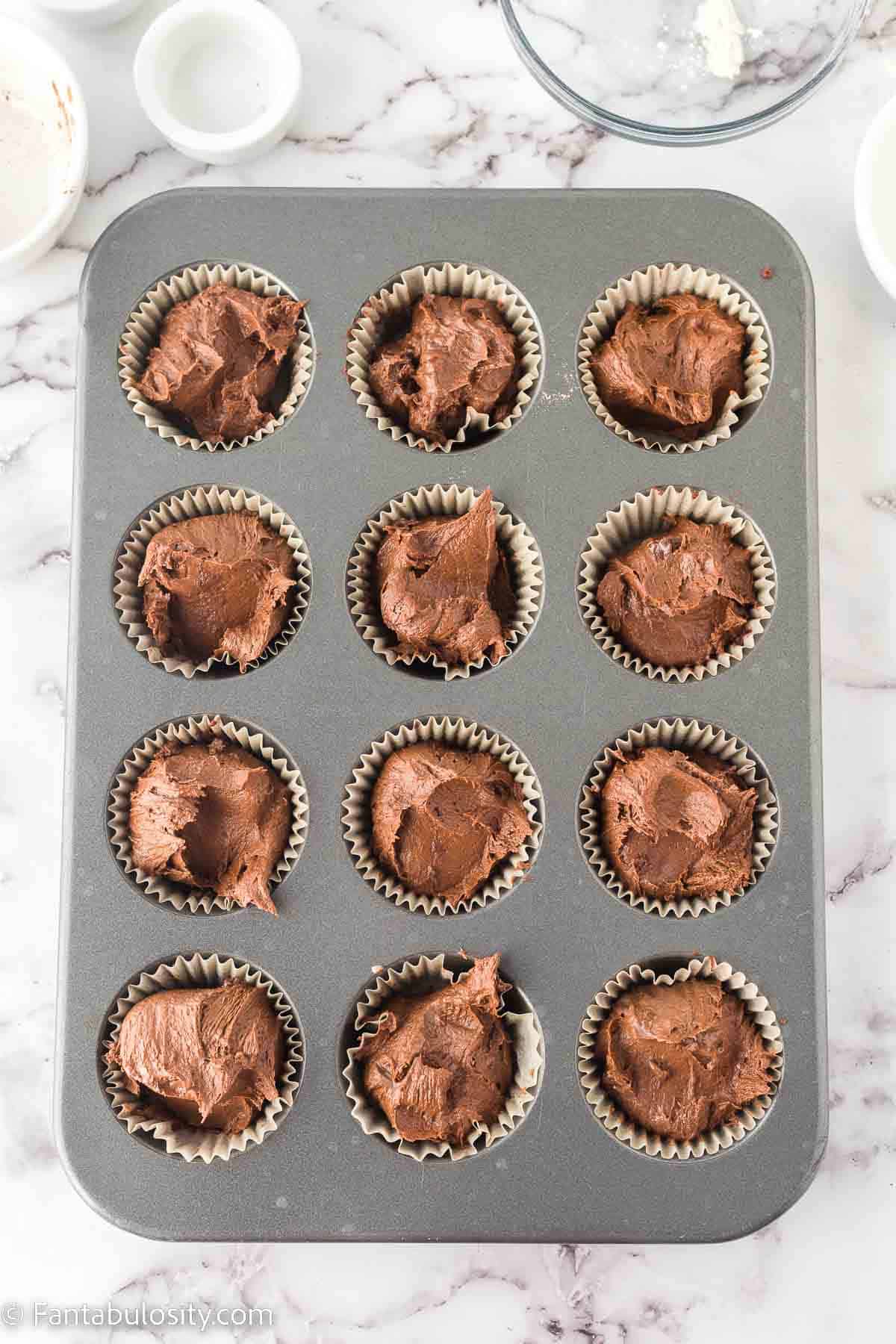 Mint chocolate cupcake batter in muffin pans.