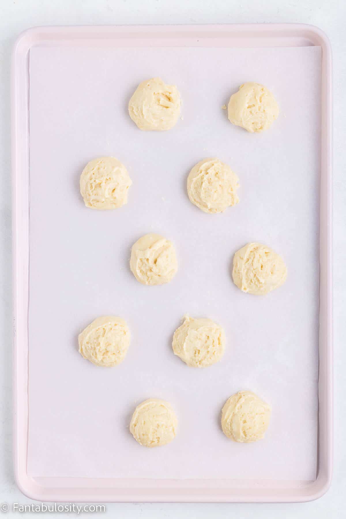 Raw cookie dough on baking sheet for bunny cookies.