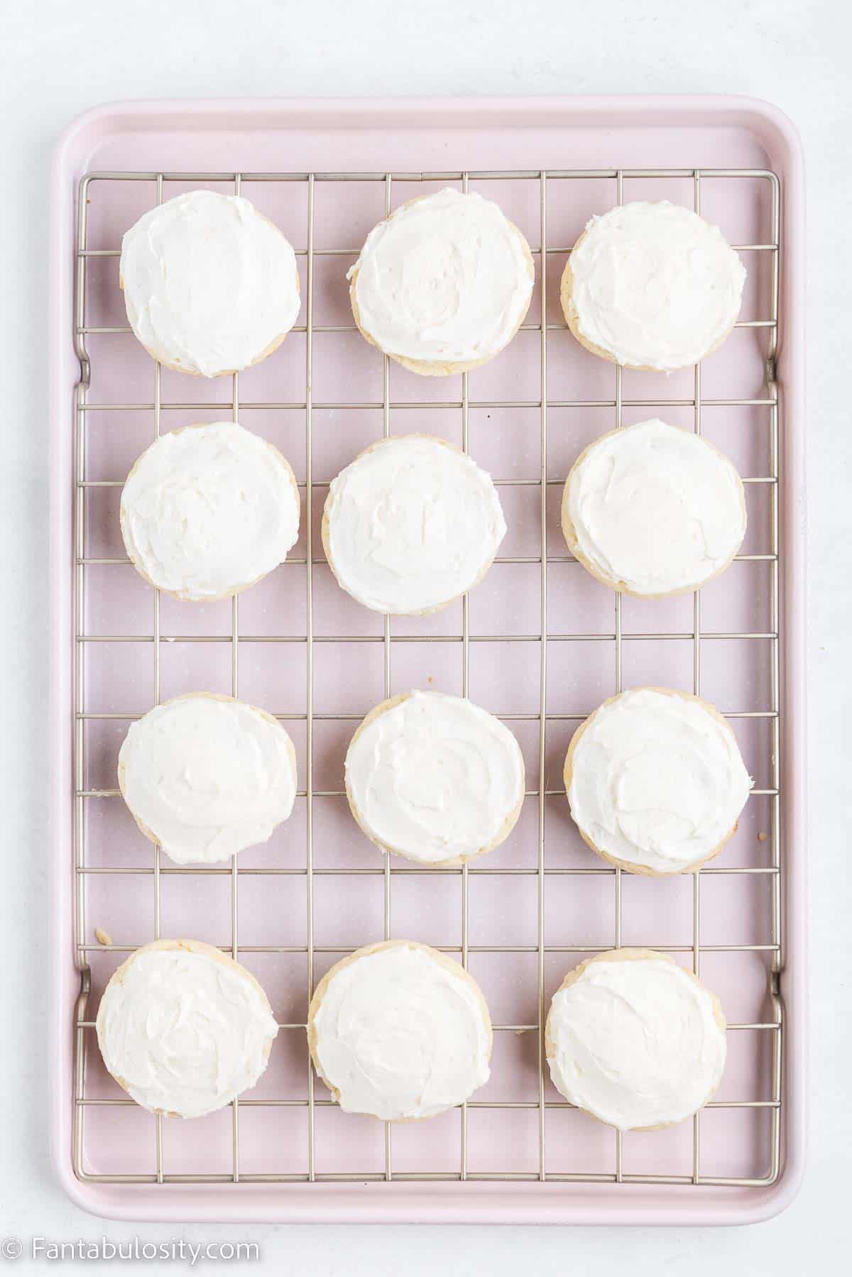 Frosted cookies on wire rack.