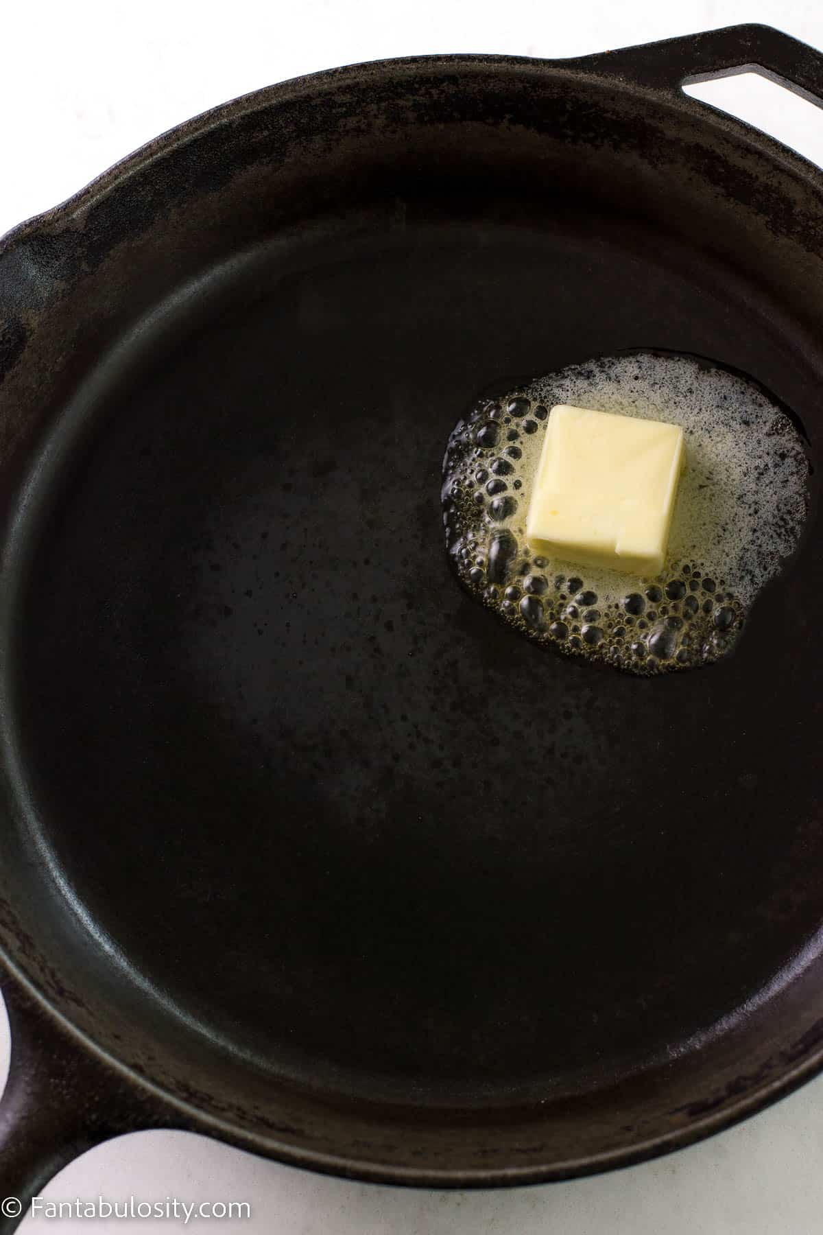 Butter melting in cast iron pan.