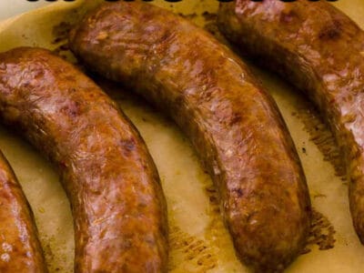 Cooked sausages in baking dish with text on the image.