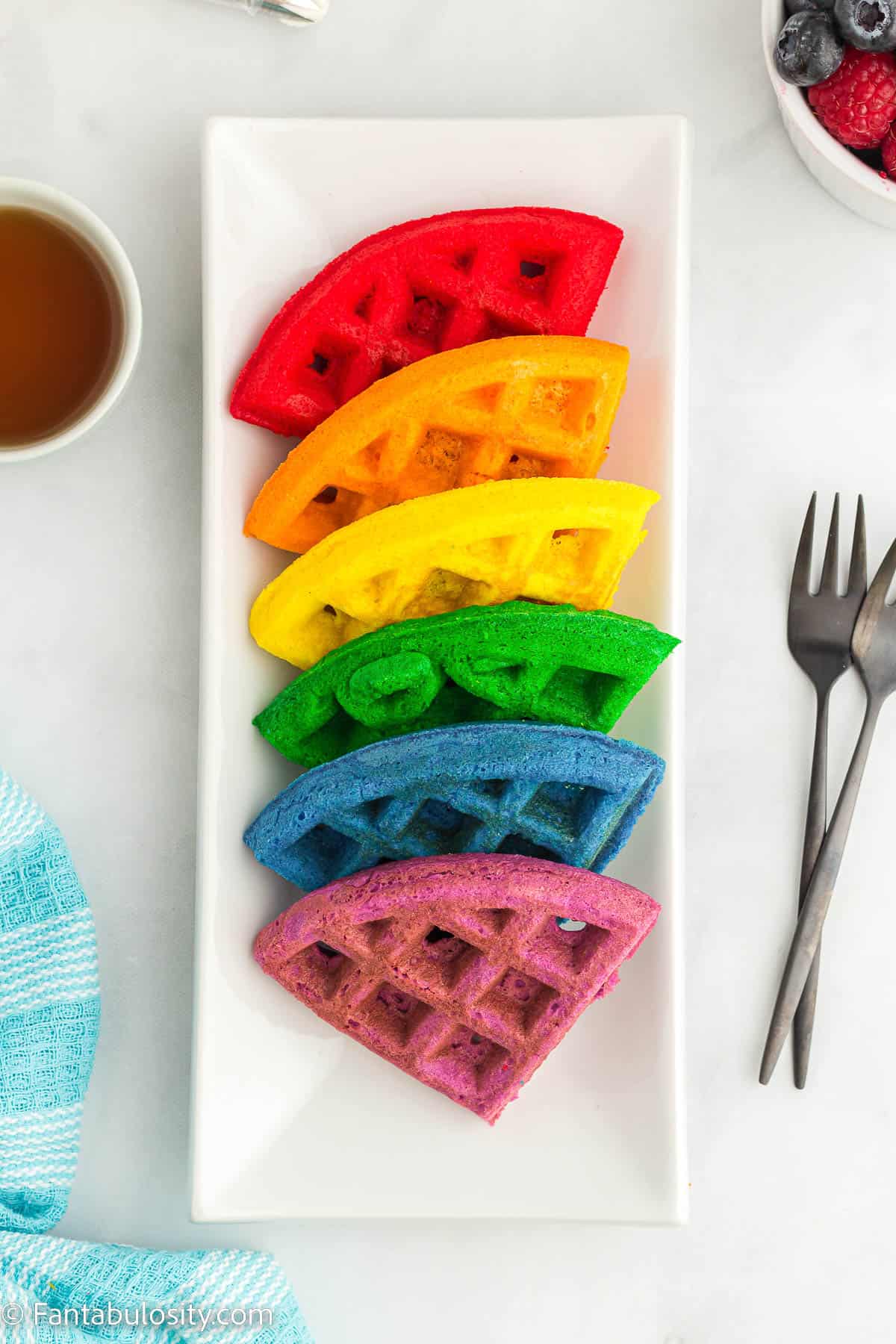 Colored waffles arranged on a white plate.