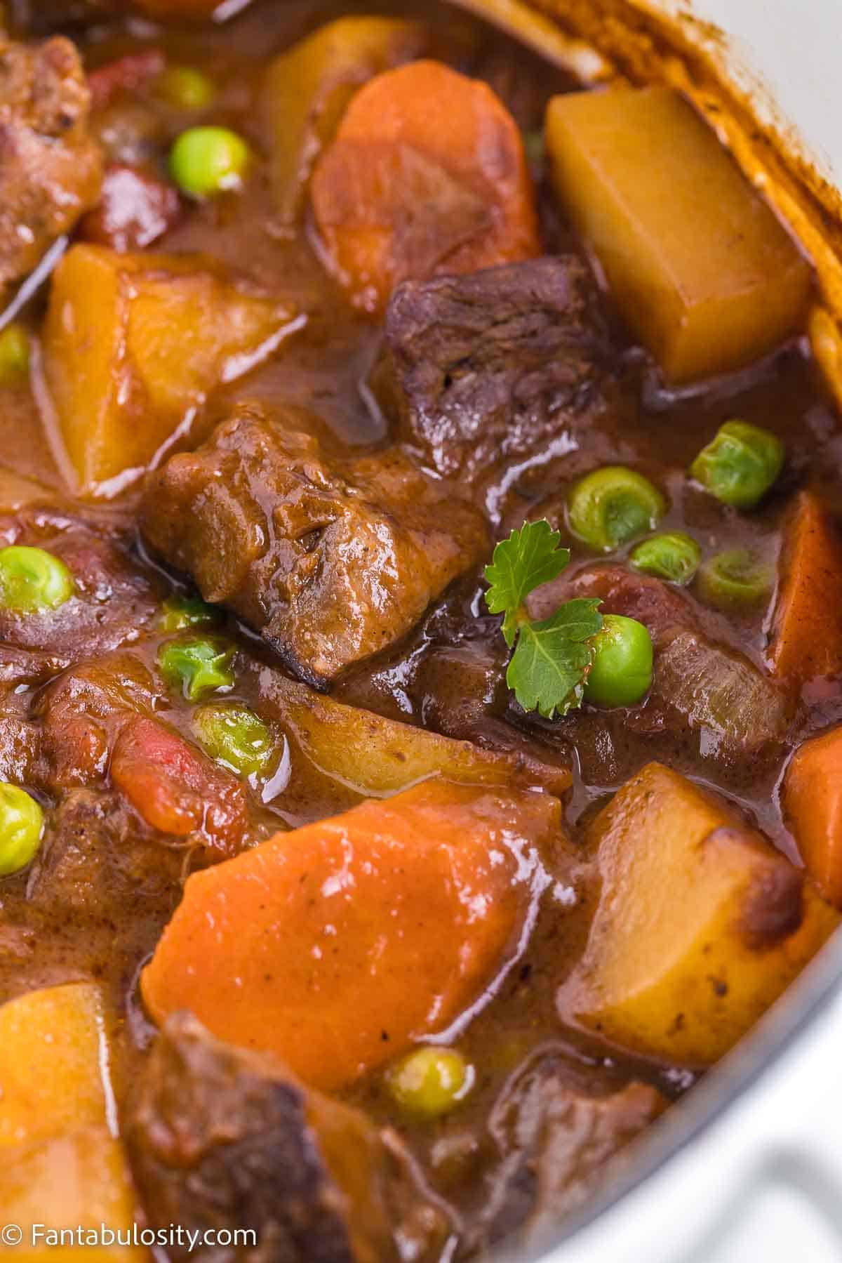 Close up of beef stew in a dutch oven.