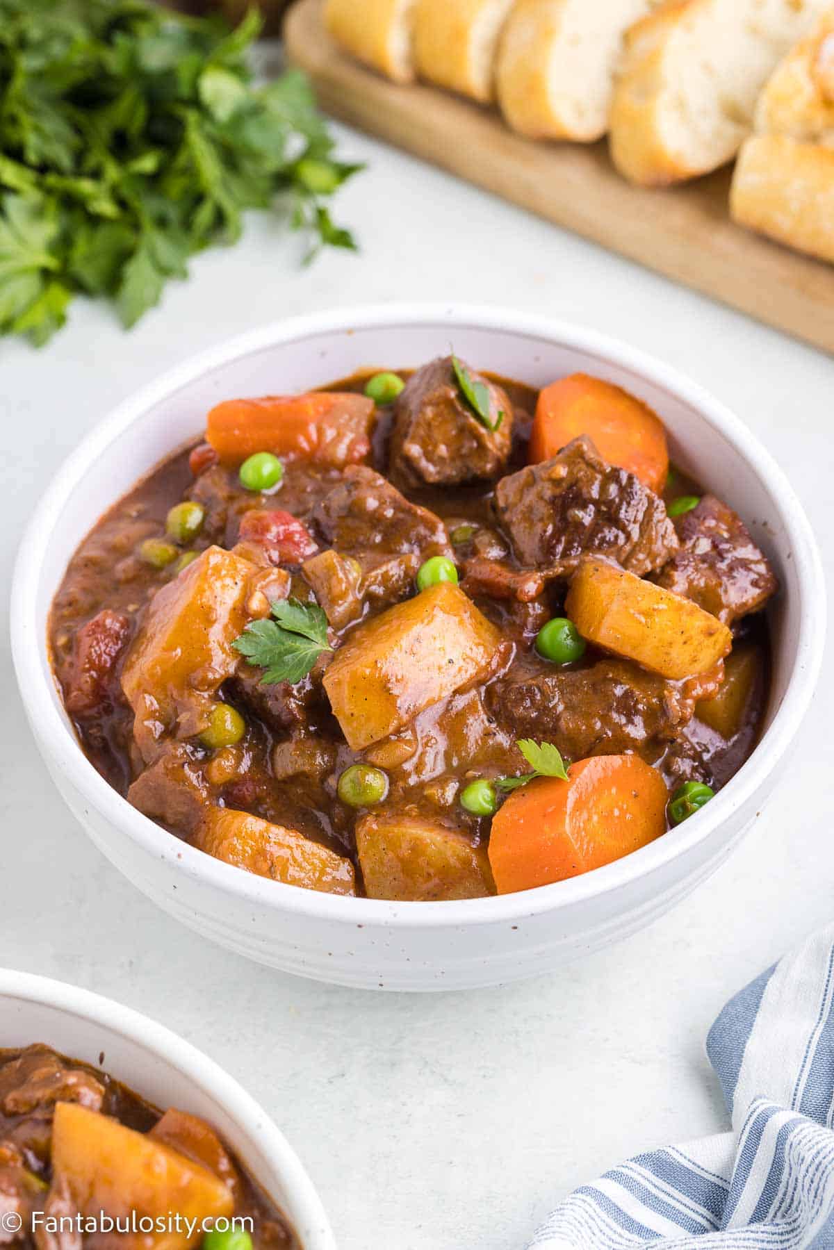 White bowl of a serving of dutch oven beef stew.