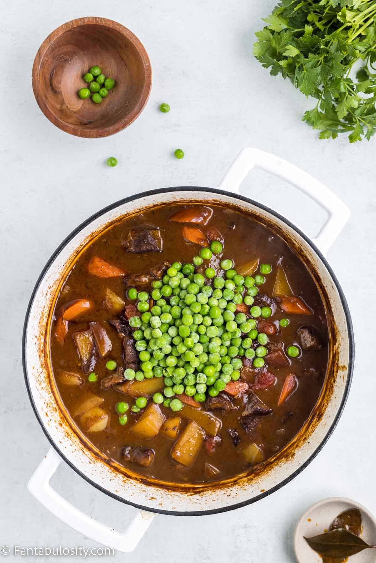 Frozen peas added to dutch oven full of beef stew.