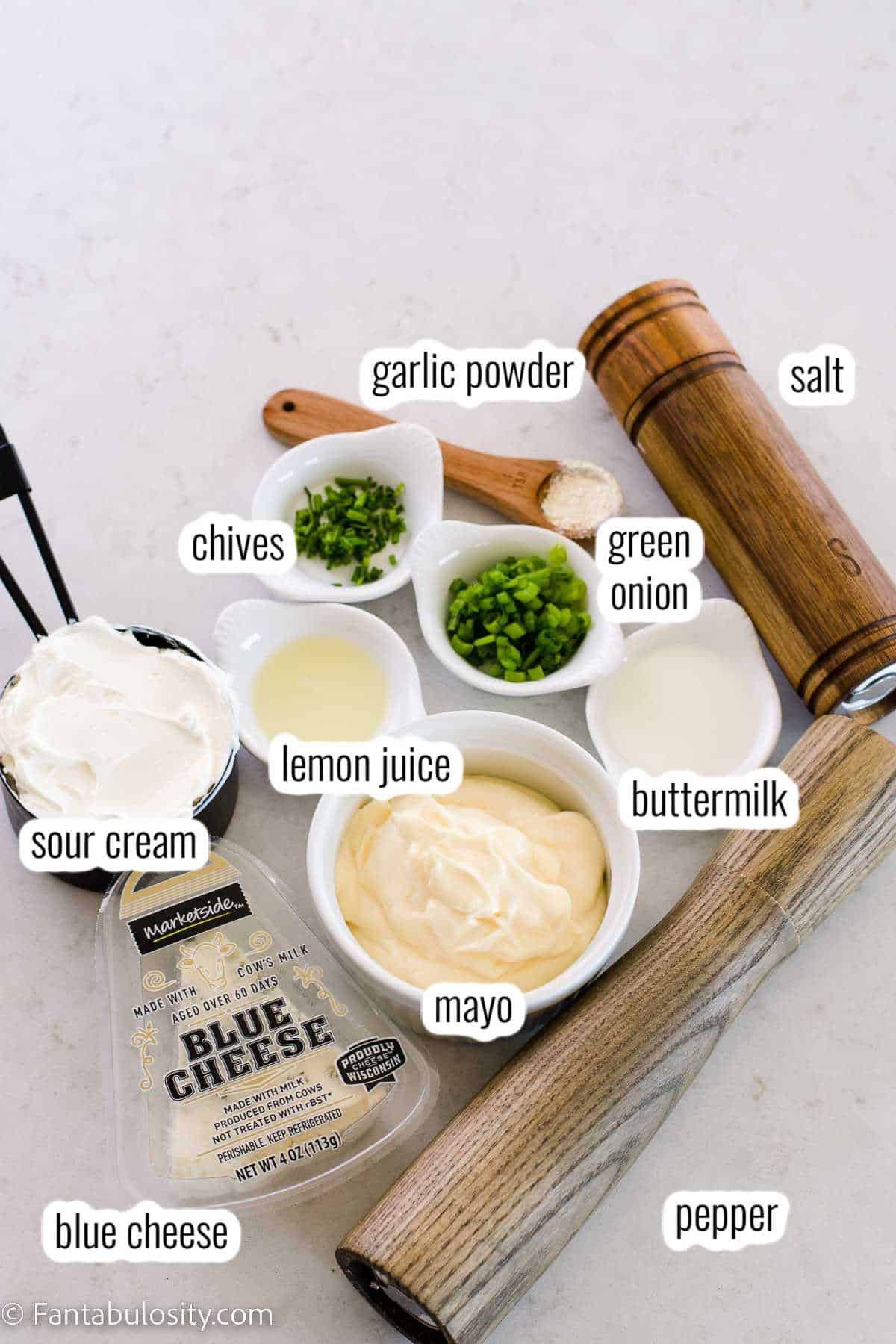 Labeled ingredients on white counter for blue cheese dip.