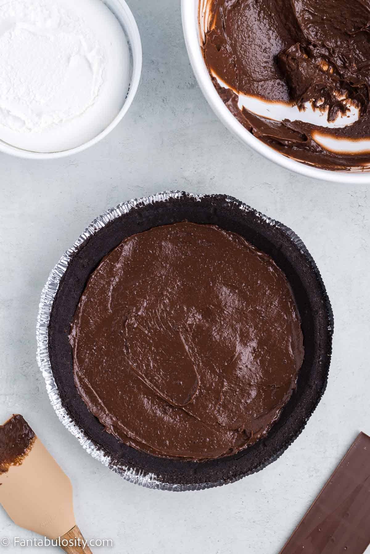 Chocolate pie filling inside of chocolate pie crust.