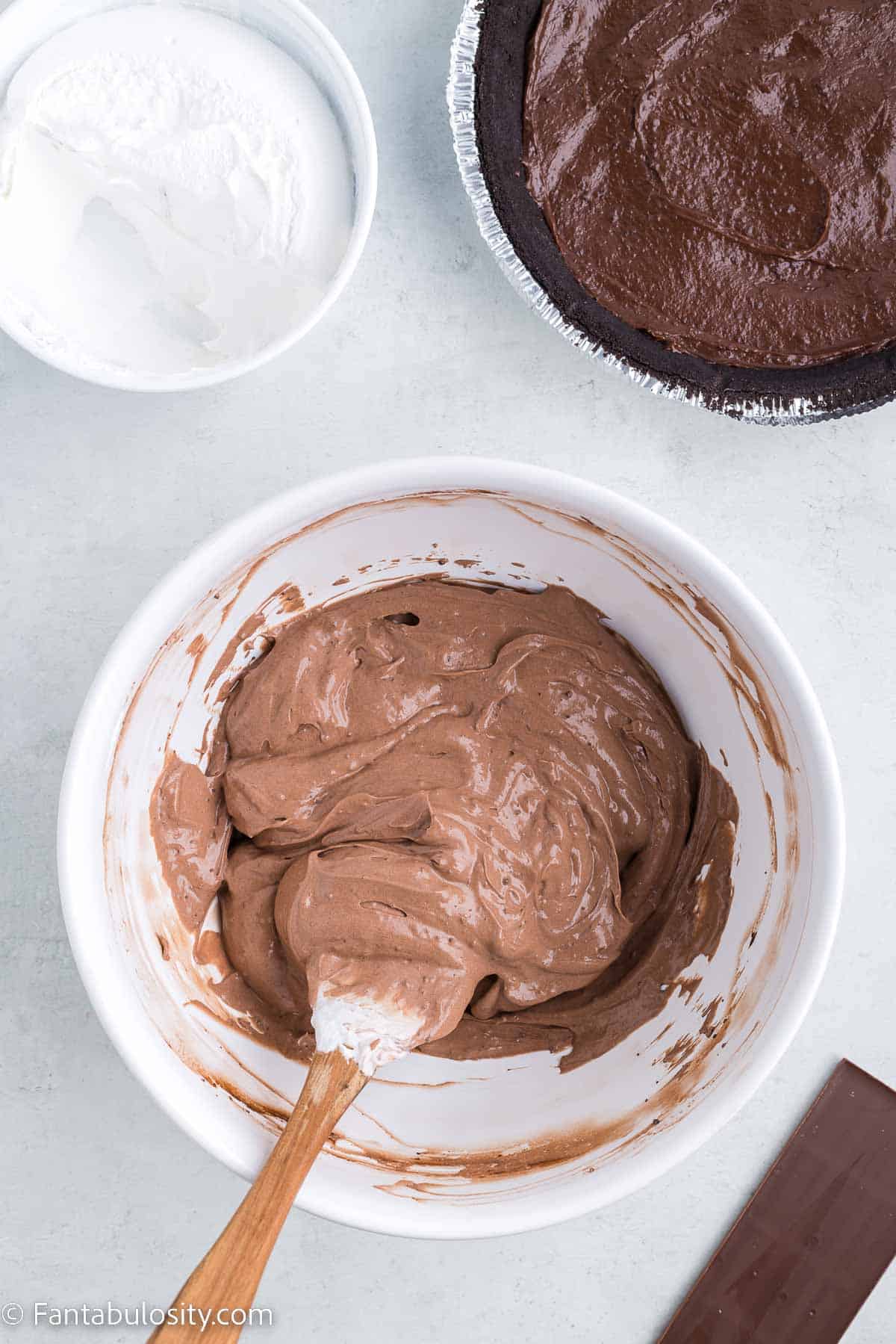 Chocolate and whipped cream mixture in white mixing bowl.