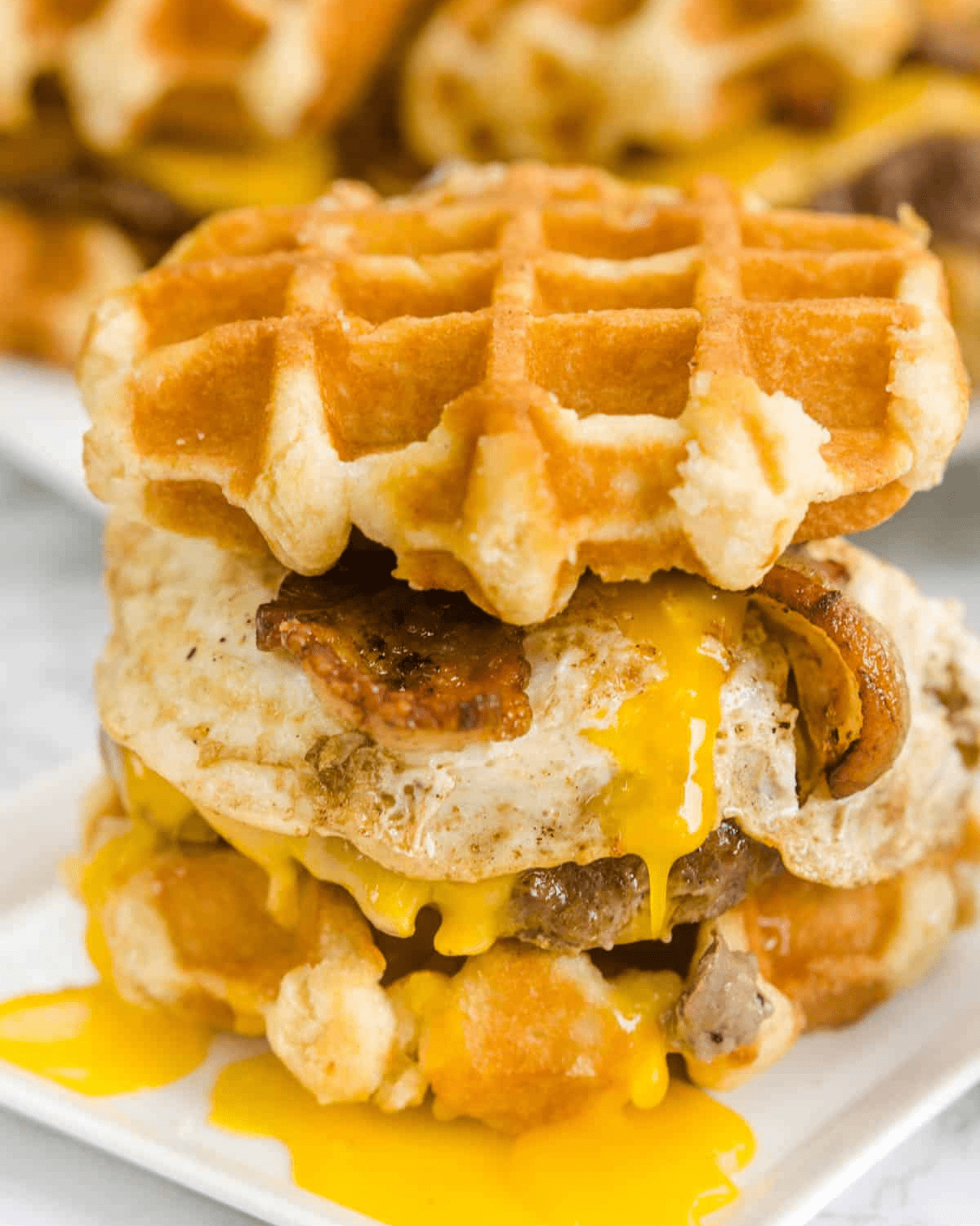 A burger served on waffles with cheese.