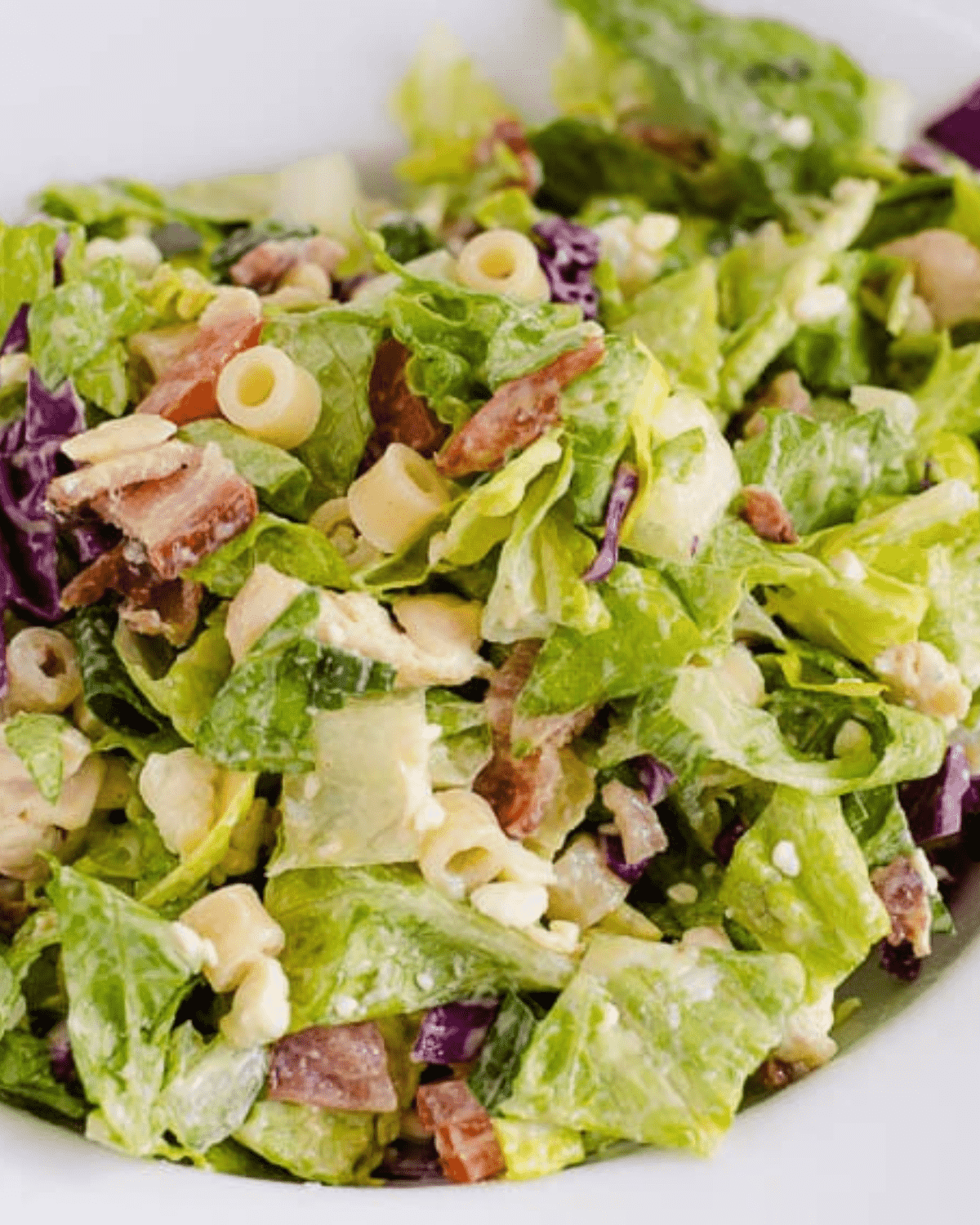 Chopped Italian salad with pasta, bacon and cheese
