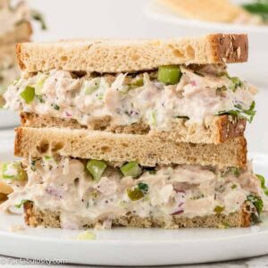 two tuna salad sandwiches stacked on top of each other