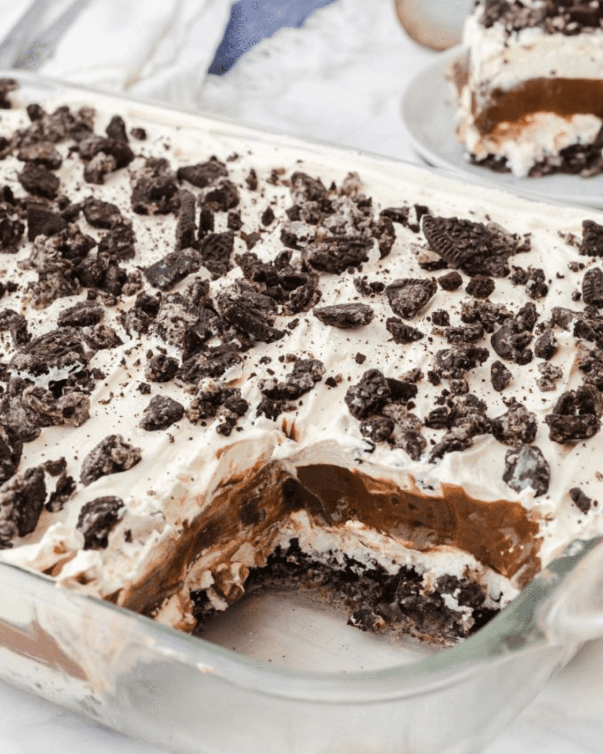Pudding, cool whip and oreo cookies layered in a baking dish