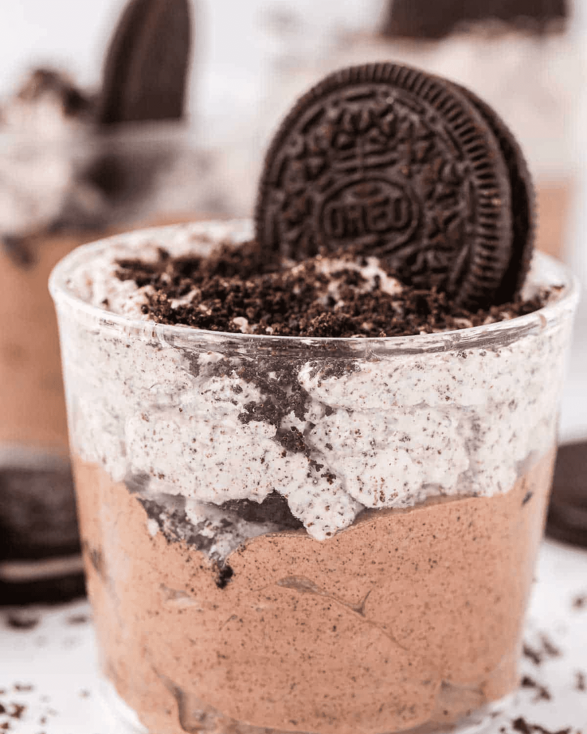 No bake oreo mousse layered in a bowl with oreo cookies
