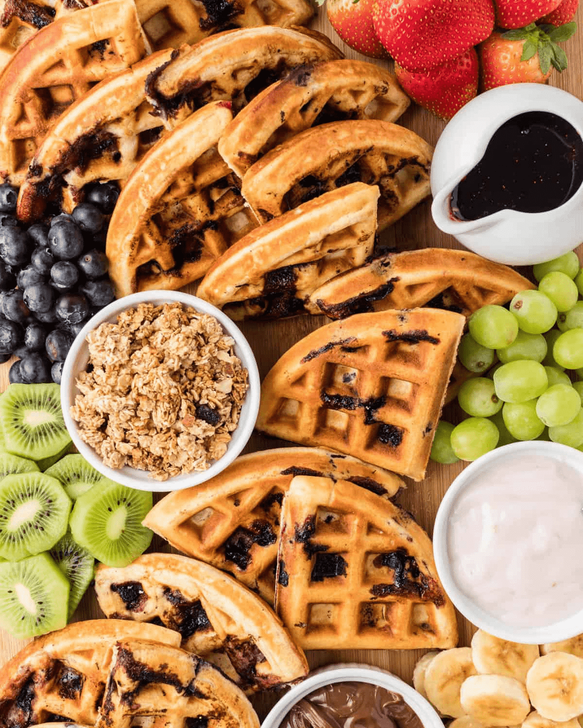 waffles and fruits on a board