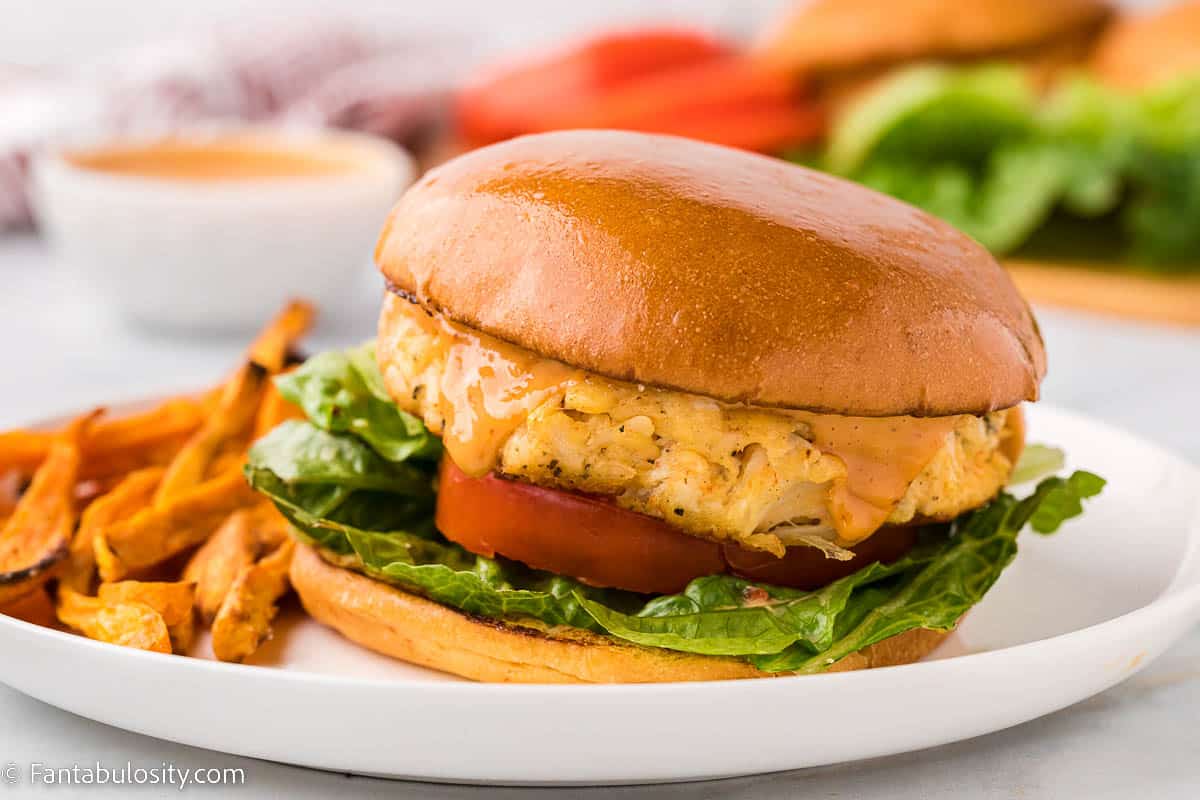 Crab cake sandwich on white plate.