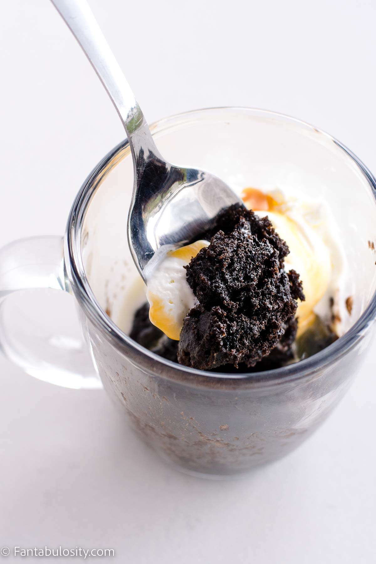 Oreo mug cake with a spoon.