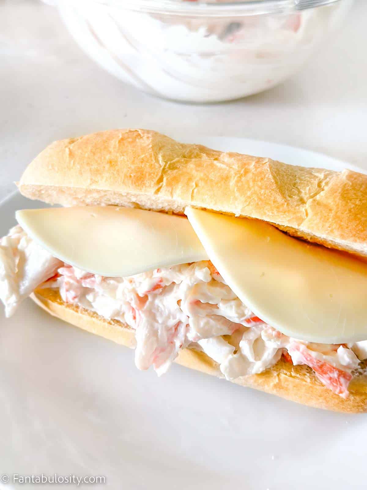 Copycat subway crab sandwich on white plate.