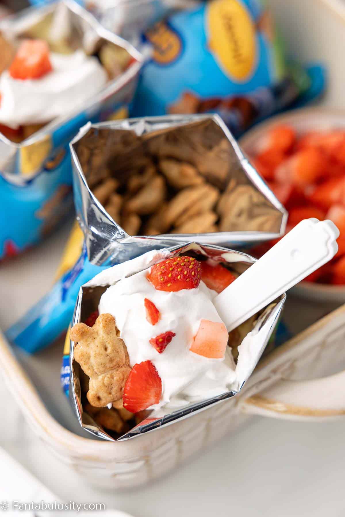 Walking dessert in dish, with plastic spoon sticking out of Teddy Graham bag.