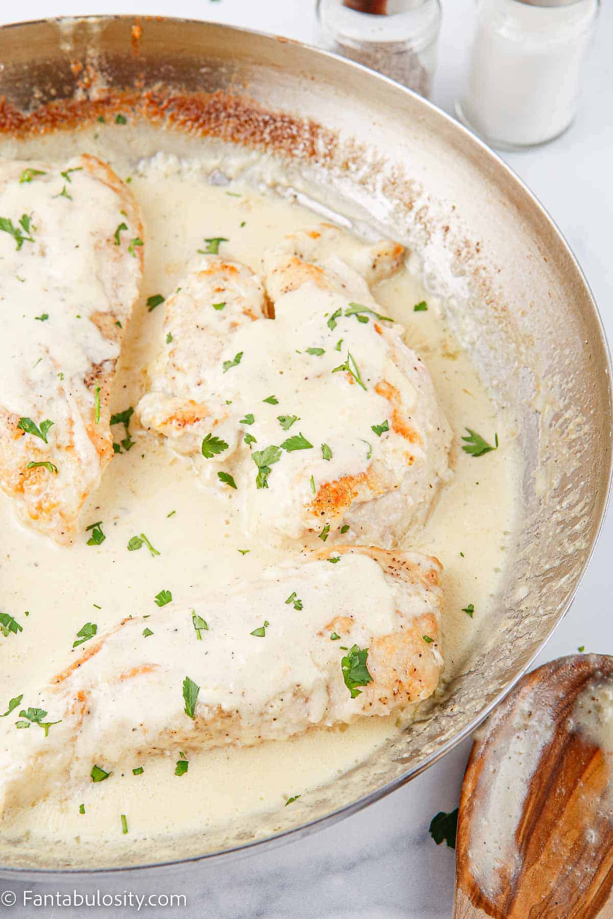 Creamy caesar chicken in skillet.