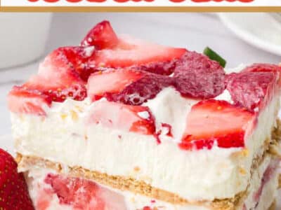 Slice of strawberry cream cheese icebox cake on white plate with red text.