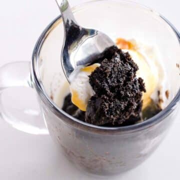 Oreo mug cake with a spoon dipped in.