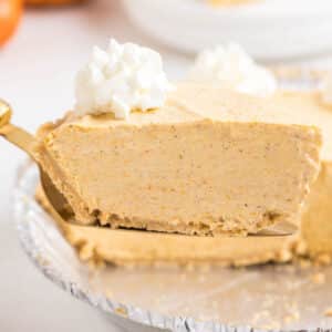 Slice of pumpkin pie made with graham cracker crust.