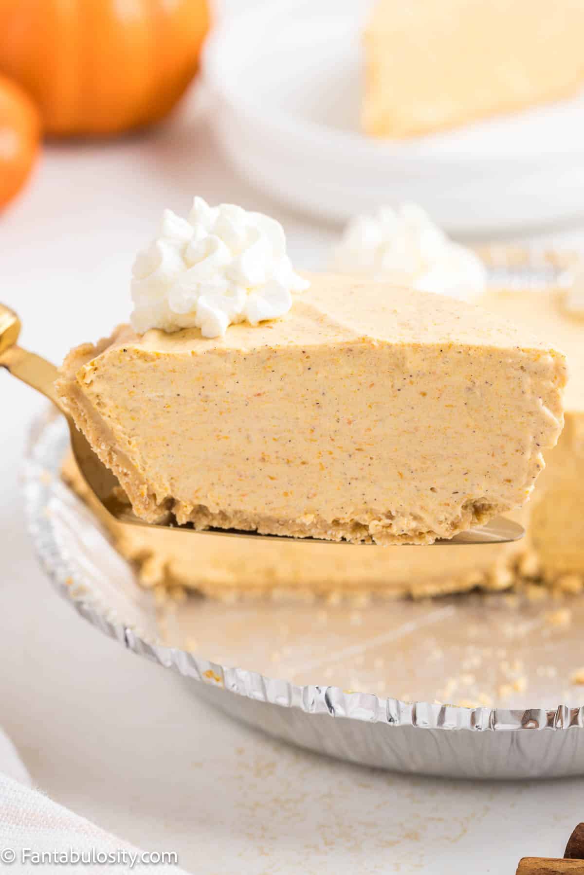 Slice of pumpkin pie on spatula. 